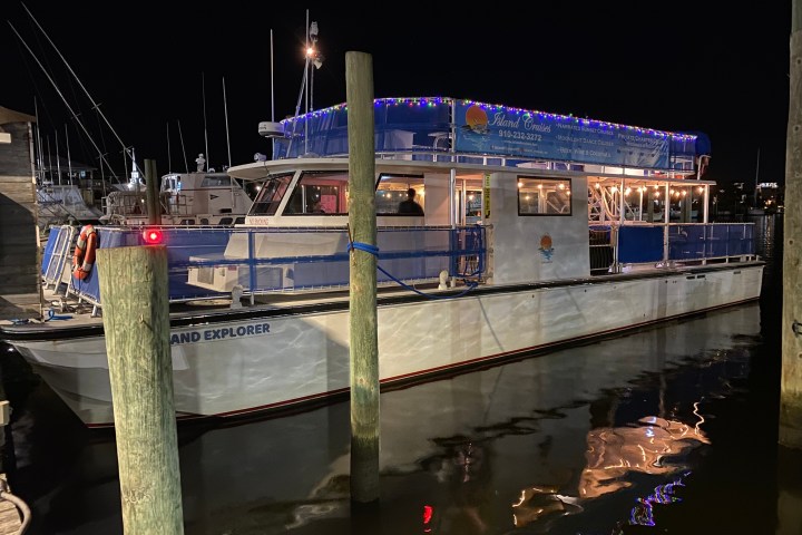 a boat is docked next to a body of water